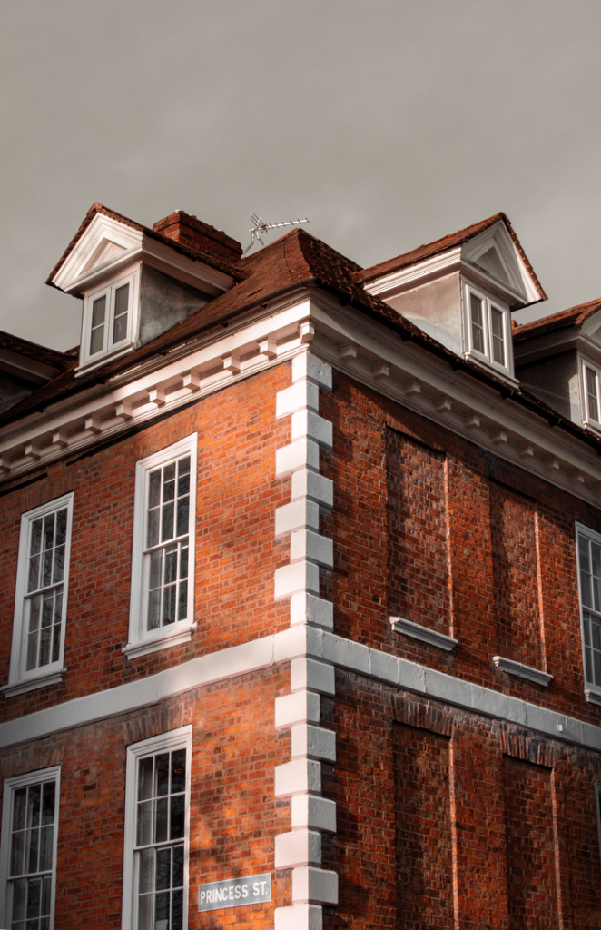 Classic British brick architecture with a dramatic dark sky in Shrewsbury, England.